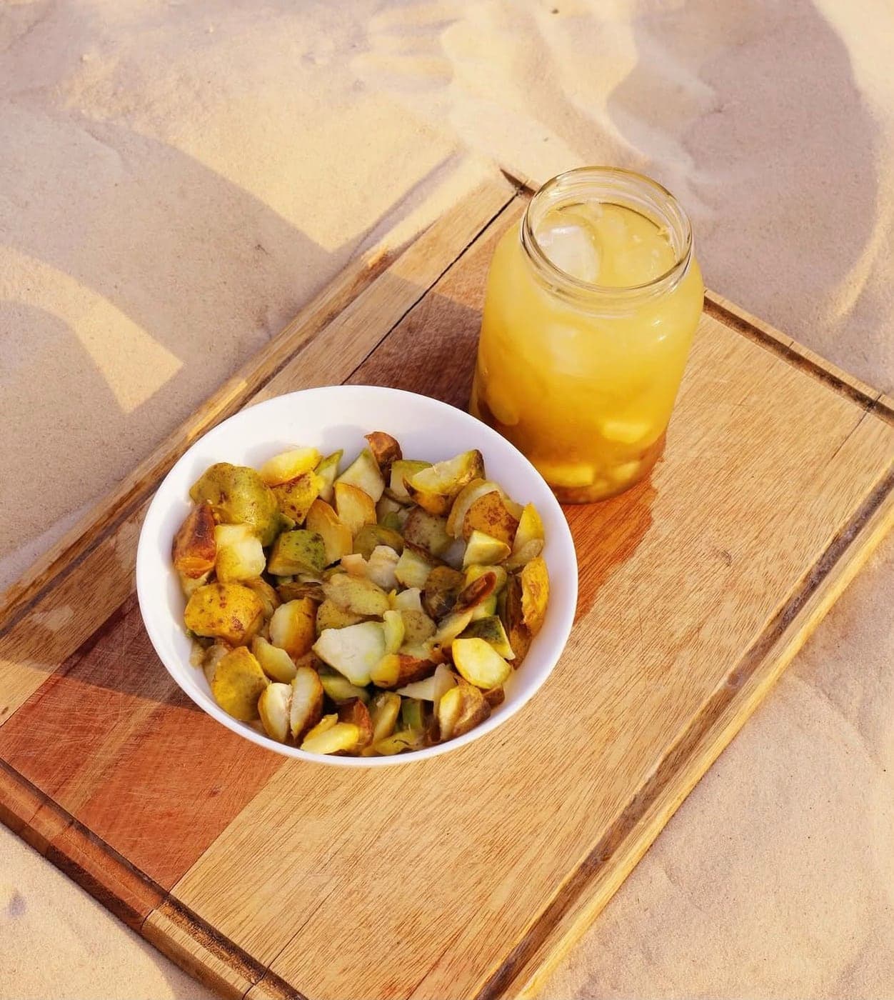 Batata rústica com drink na areia